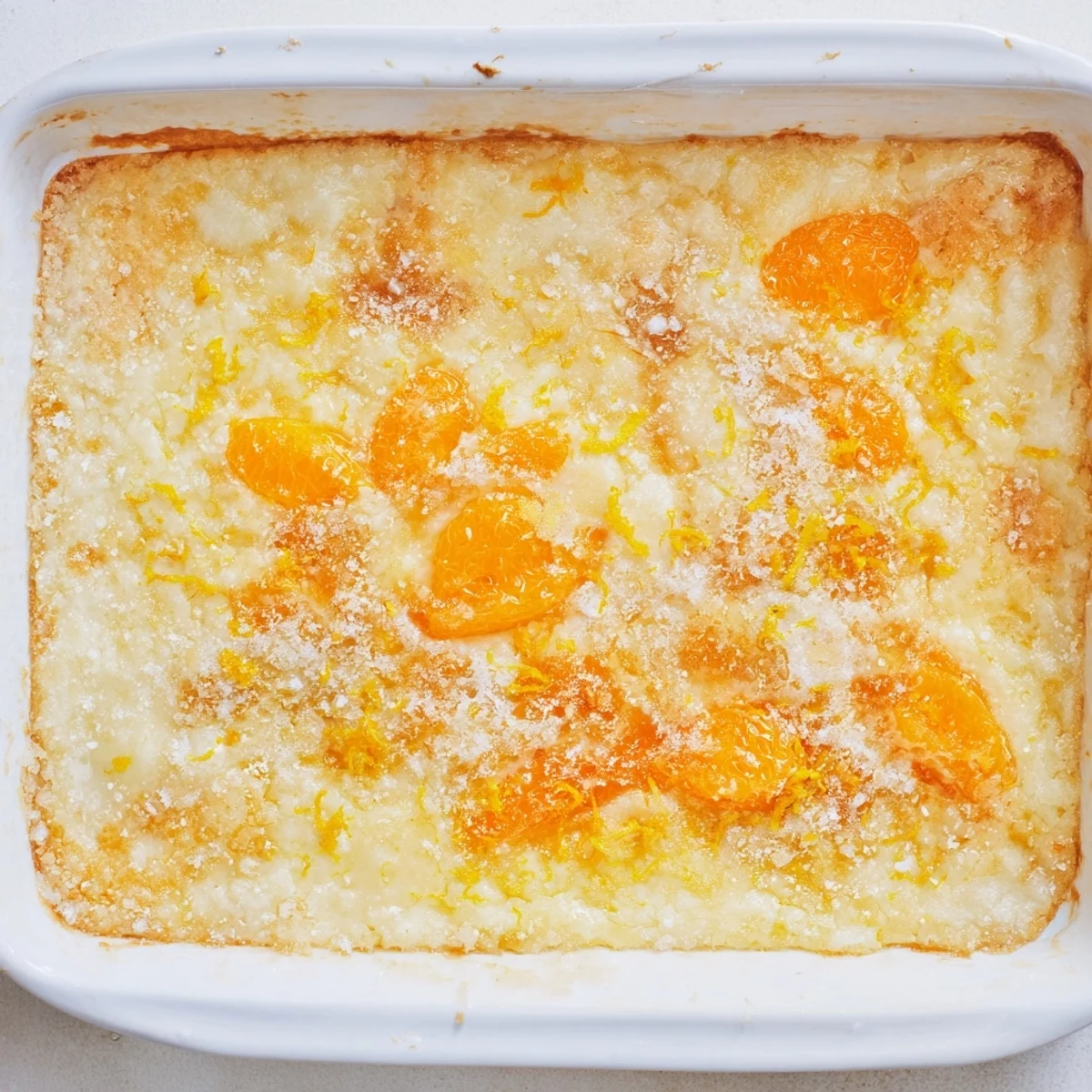 Zesty lemon dump cake baked until golden with mandarin oranges peeking through the crust