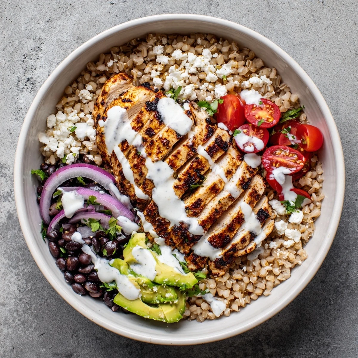 Golden grilled chicken slices atop colorful street corn chicken bowl with charred corn, black beans, and zesty yogurt-lime dressing drizzled generously