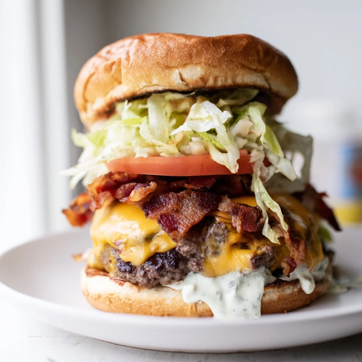 Golden brown Crack Burger with melted cheddar, crispy bacon, and fresh tomato slices on toasted bun
