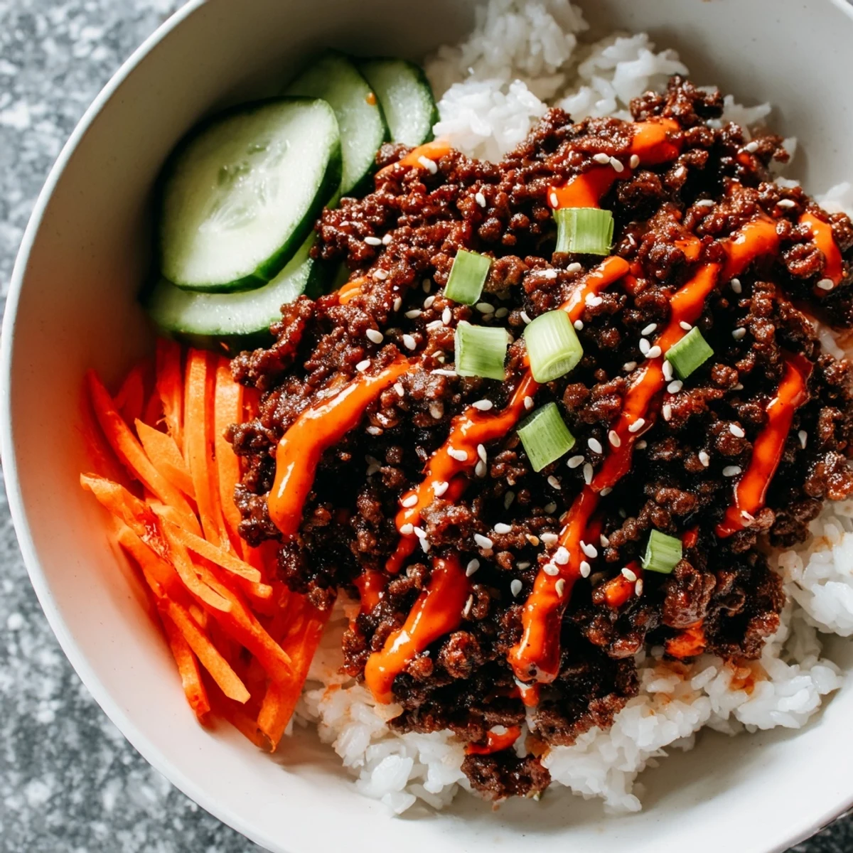 Savory Korean-style ground beef served in a bowl with crisp veggies and creamy spicy mayonnaise topping