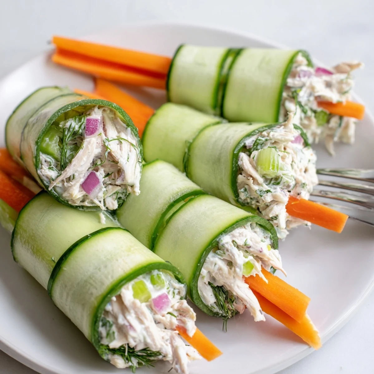 Fresh cucumber ribbons wrapped around creamy chicken salad for a light appetizer