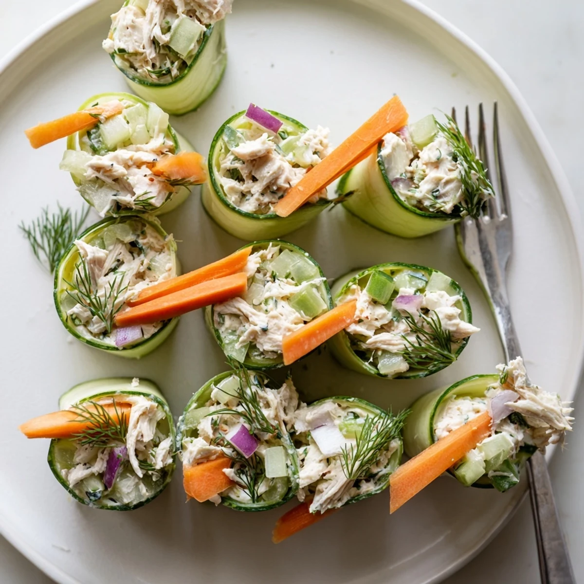 Low-carb cucumber roll ups filled with creamy chicken salad and fresh dill