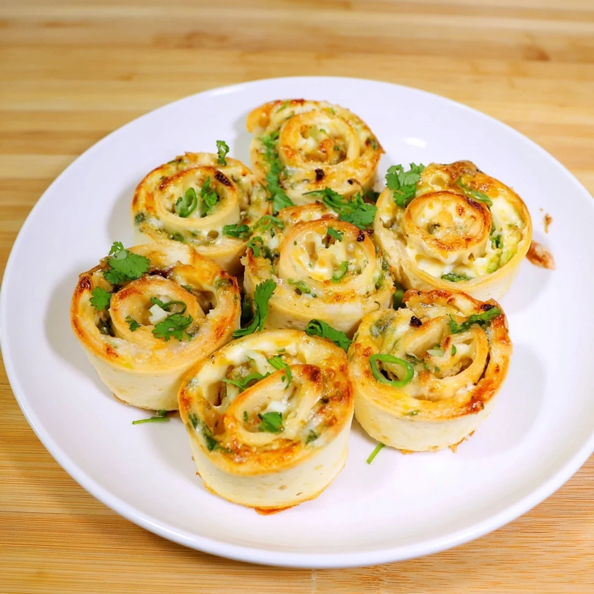  Spiral slices of creamy cheese and jalapeño filled Easy Jalapeno Popper Pinwheels fresh from the oven