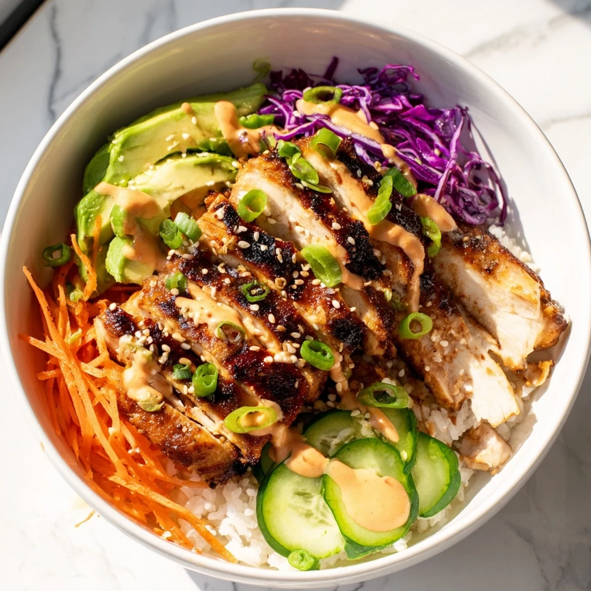 Succulent Korean BBQ chicken served over steamed jasmine rice with crisp veggies, sliced avocado, and garnish of sesame seeds and green onions