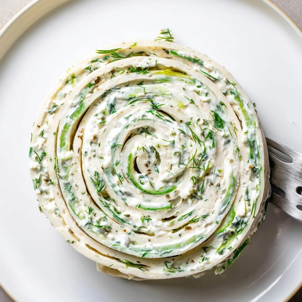 Platter of Pickle Dip Pinwheels showing creamy, tangy spirals with dill