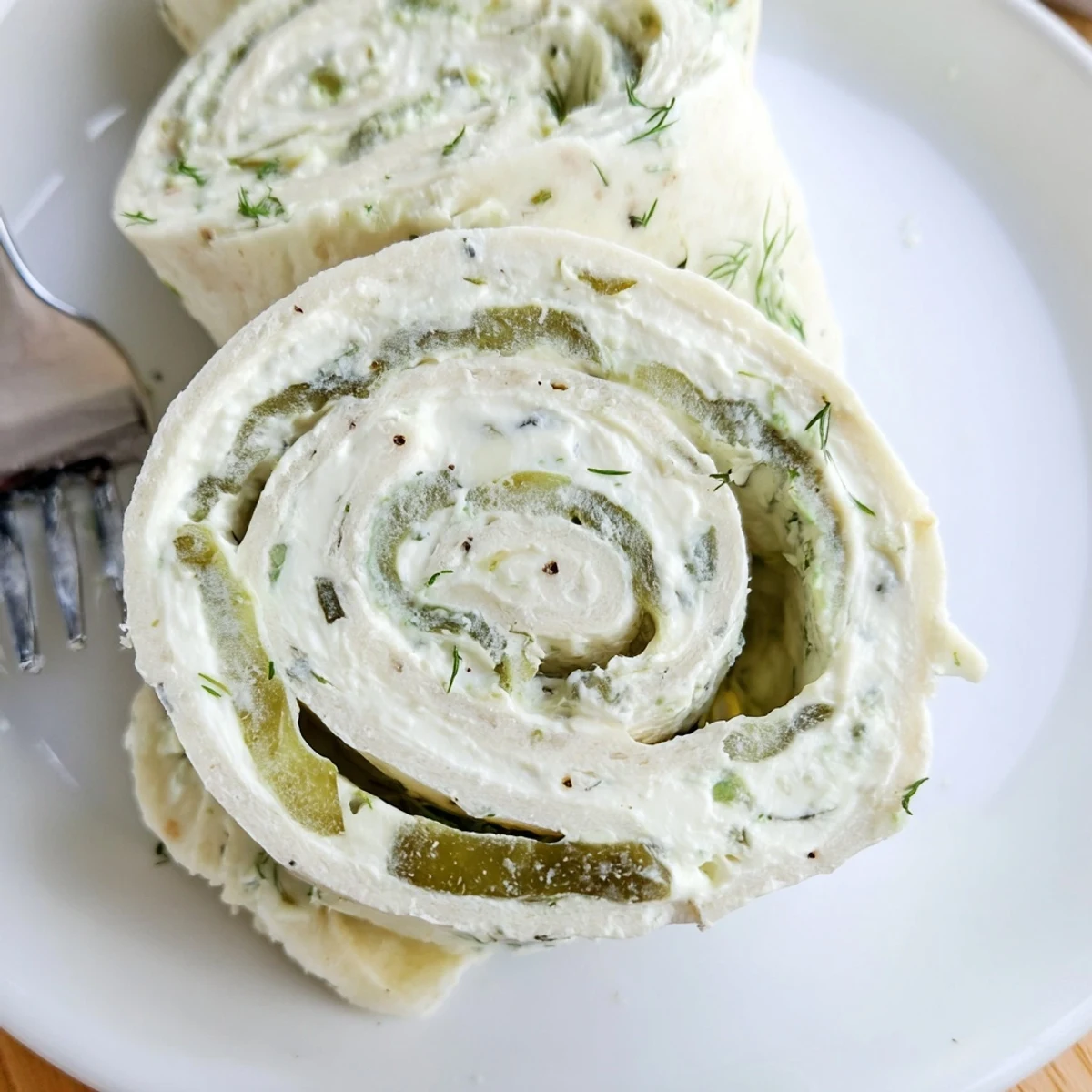 Chilled Pickle Dip Pinwheels sliced into bite sized rounds, tangy cream cheese