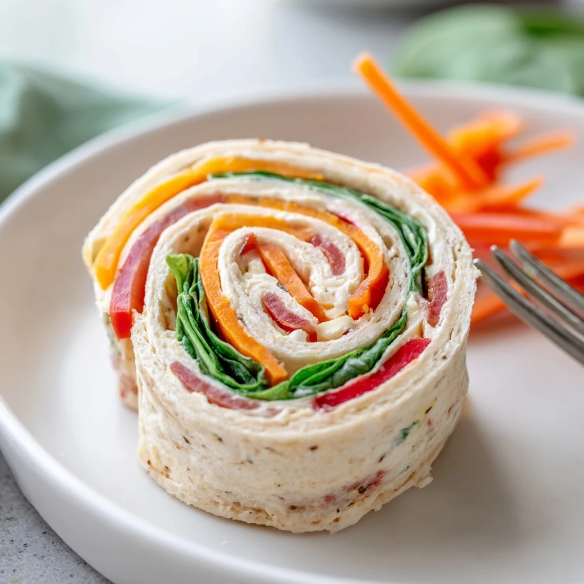 Party-ready Pinwheel Sandwiches arranged on a picnic plate, ready to grab.
