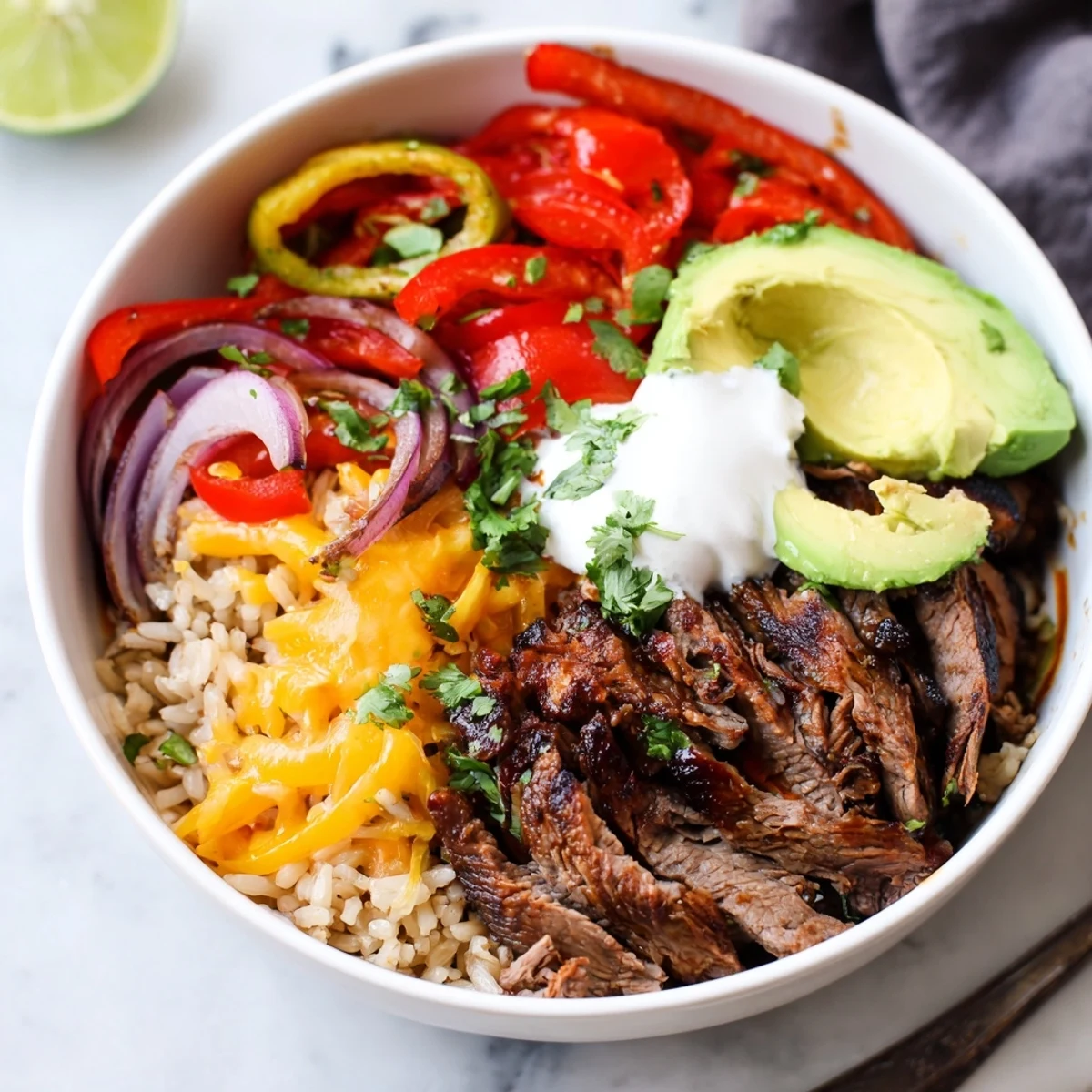 Served hot, Steak Fajita Power Bowls showcase black beans, melted cheese, cilantro
