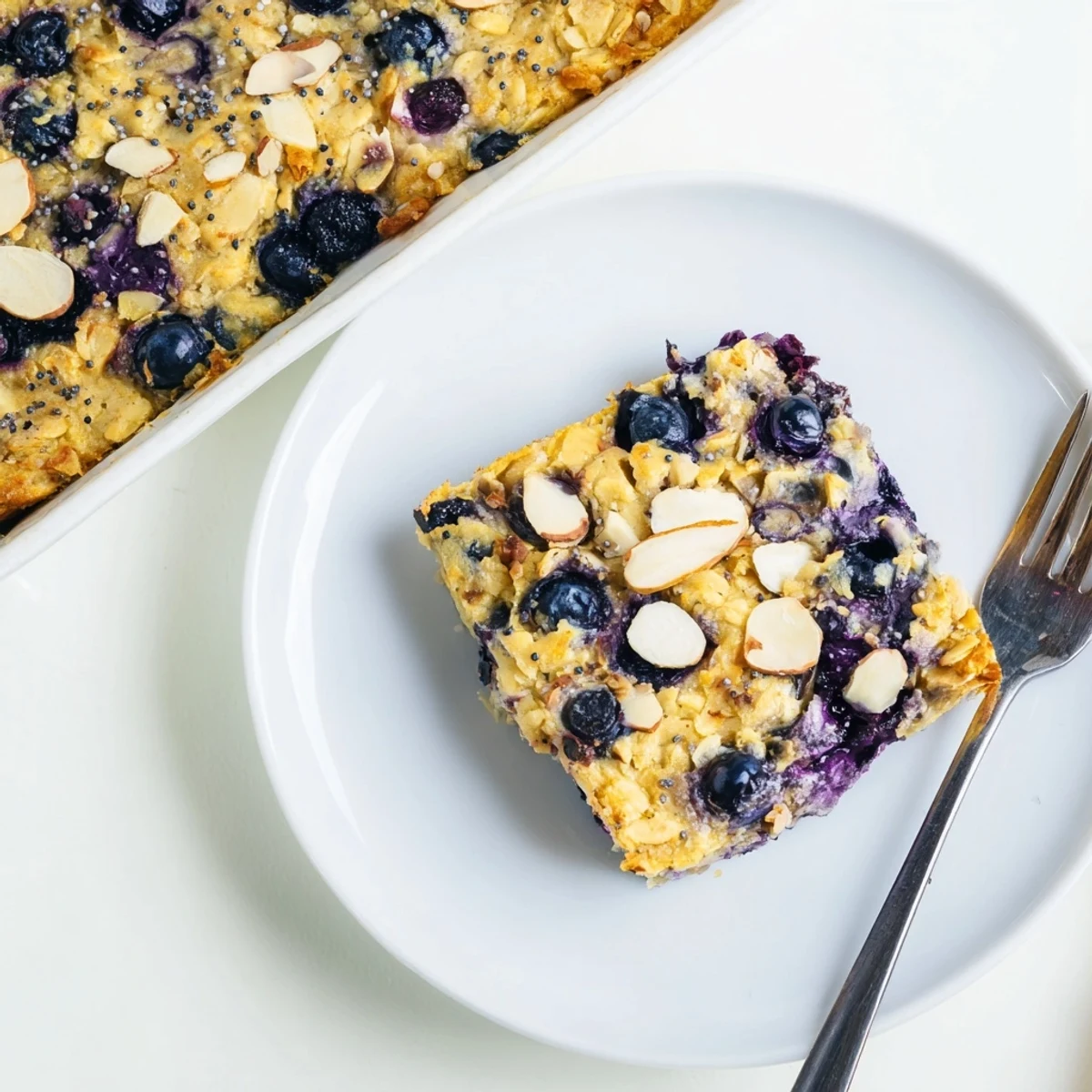 Warm breakfast bake with tangy lemon and sweet blueberries on a white plate