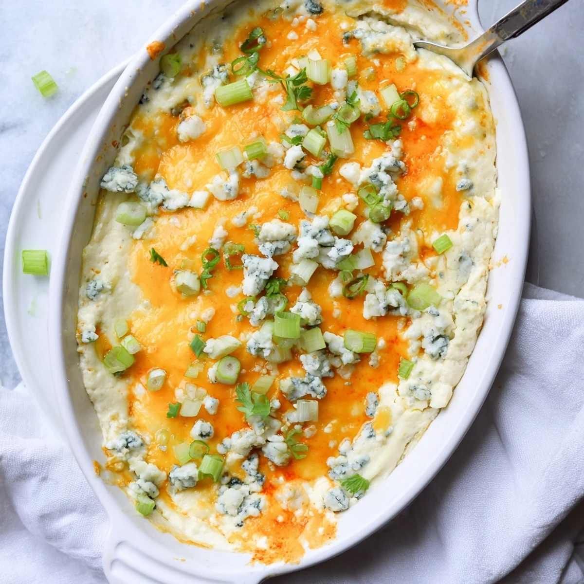 Hot baked cheesy white bean buffalo dip served with tortilla chips for game day