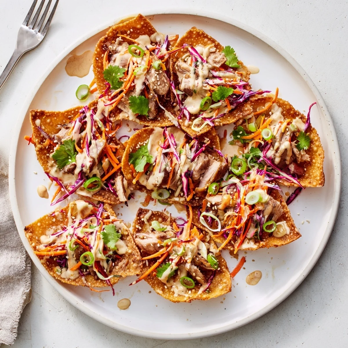 Handheld crispy wonton tacos stuffed with savory Asian chicken and vibrant red green cabbage slaw garnish
