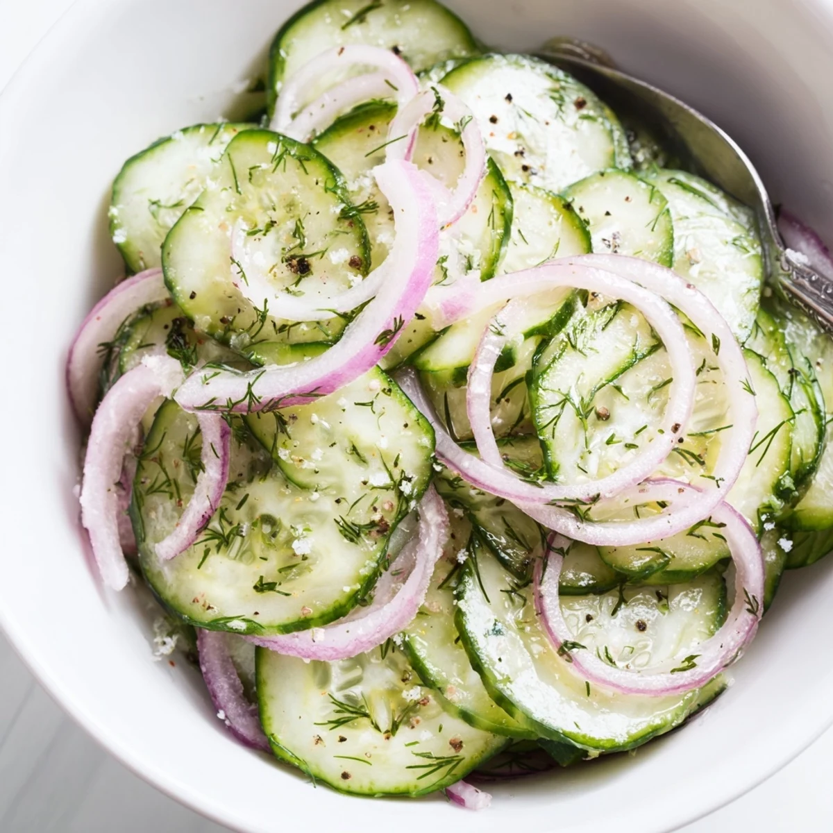 Simple Cucumber Salad garnished with dill, crunchy slices perfect with grilled chicken
