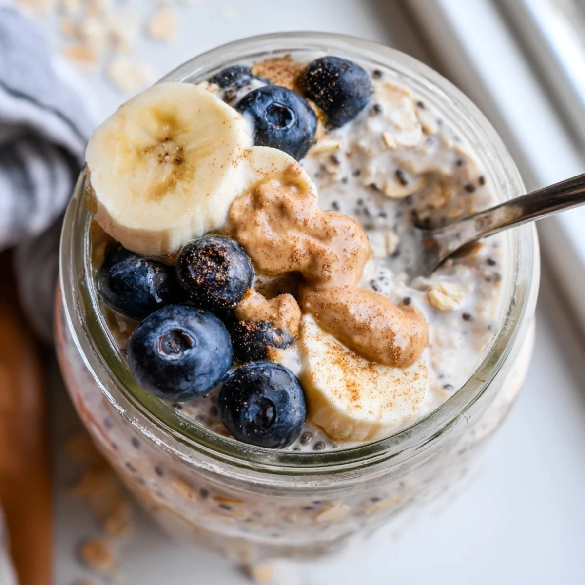 Velvety protein overnight oats served cold with a nut butter drizzle
